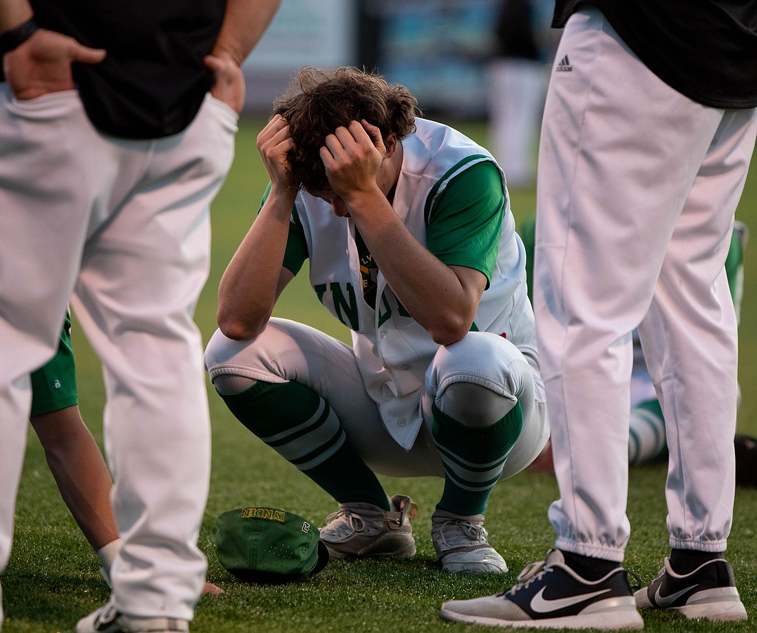 Lynden junior pitcher Lane Simonsen holds his head in his hands May 27 after the Lions lost 2-1 to Tumwater in the 2A state baseball championship at Joe Martin Stadium.