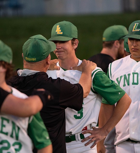 Lynden head coach Cory White holds the shoulders of senior Coston Parcher.