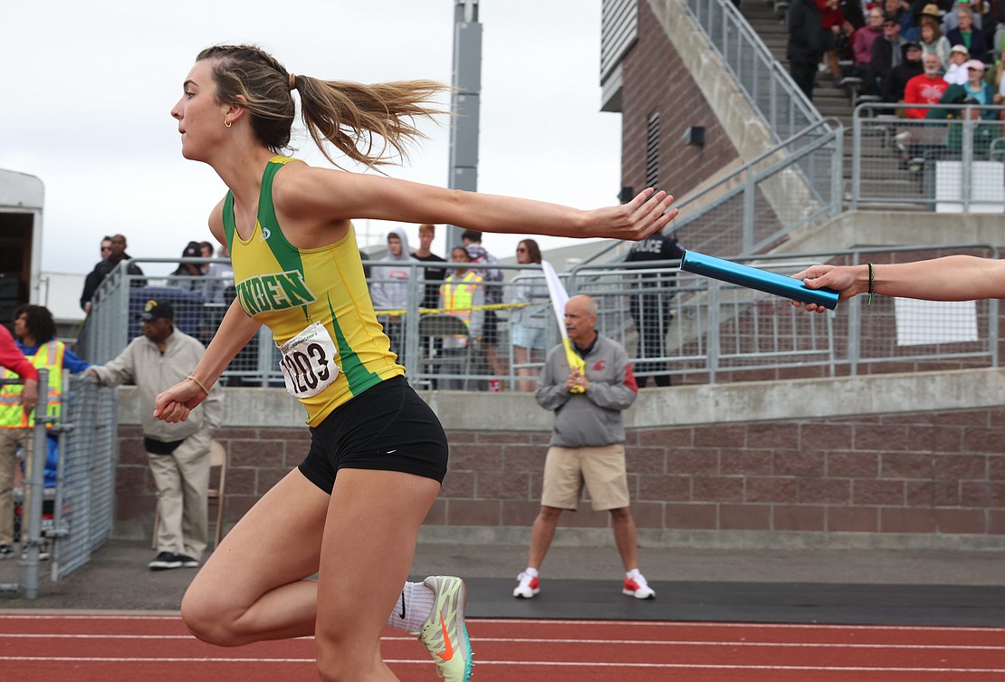 Lynden’s Faith VanBrocklin reaches back and misses the handoff in the girls 4X200 relay.