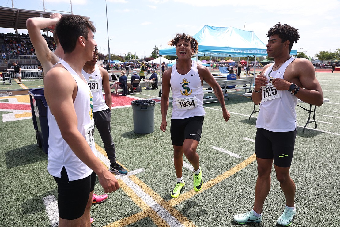 Simulating his leg of the race, Sehome’s Andre Watson talks about the team’s one one-hundredth of a second win in the boys 4X100 relay.