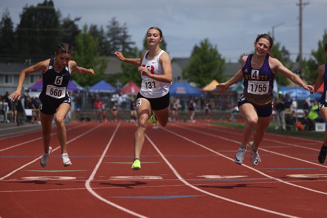 Bellingham's Chayse Flick-Williams, middle, is edged by Rogers' Ellabelle Taylor, right, in the 2A girls 100-meter dash finals.