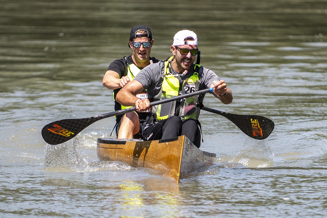 Evil Bike Company's Derek Buse and Henry TePaske paddle through the Nooksack River.