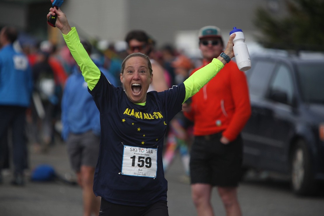 Anne Morrison of Alaska All-Stars celebrates as she begins the running leg of the race.