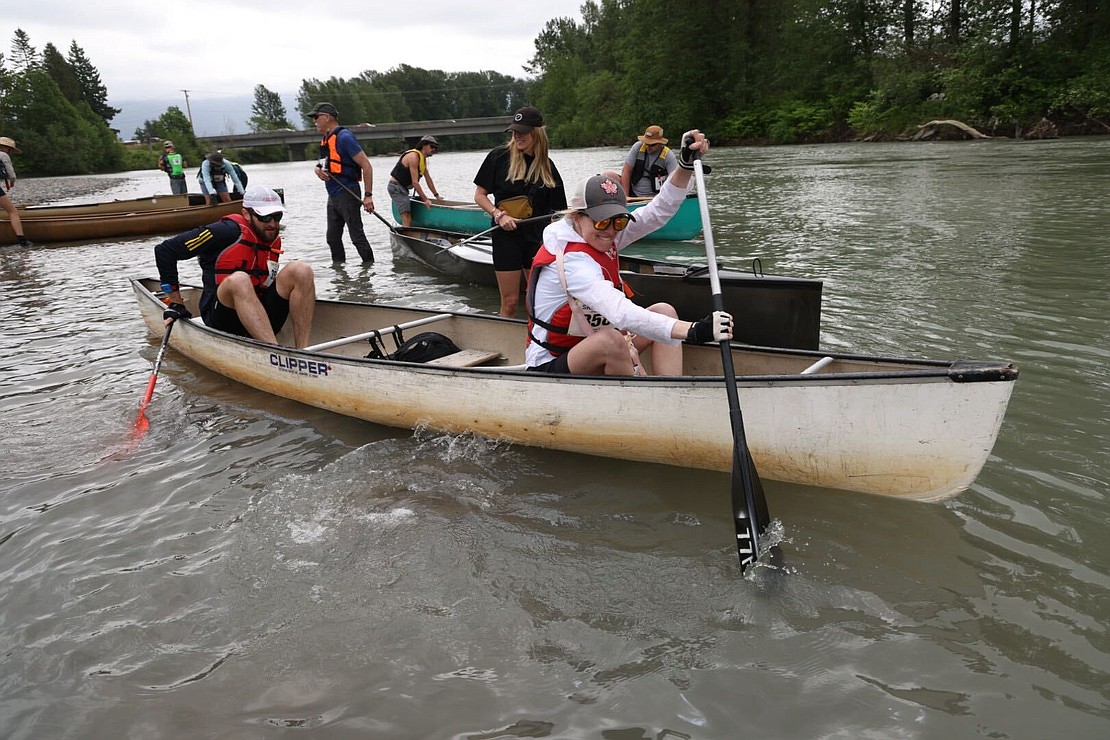 Canoeists on team Chelseas FC struggle to get moving down the Nooksack River.