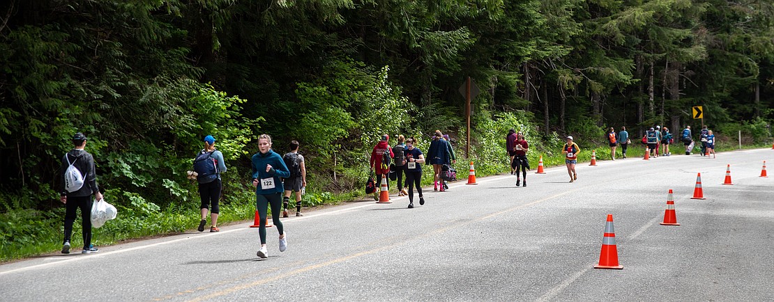 Runners make their way toward the handoff area while runners who already finished trudge back to their cars. The third leg is 8 miles and has an elevation drop of 2,200 feet.