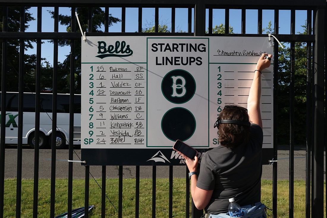 The Bellingham Bells general manager Stephanie Morrell writes the team lineups on opening day, June 2, at Joe Martin Stadium.