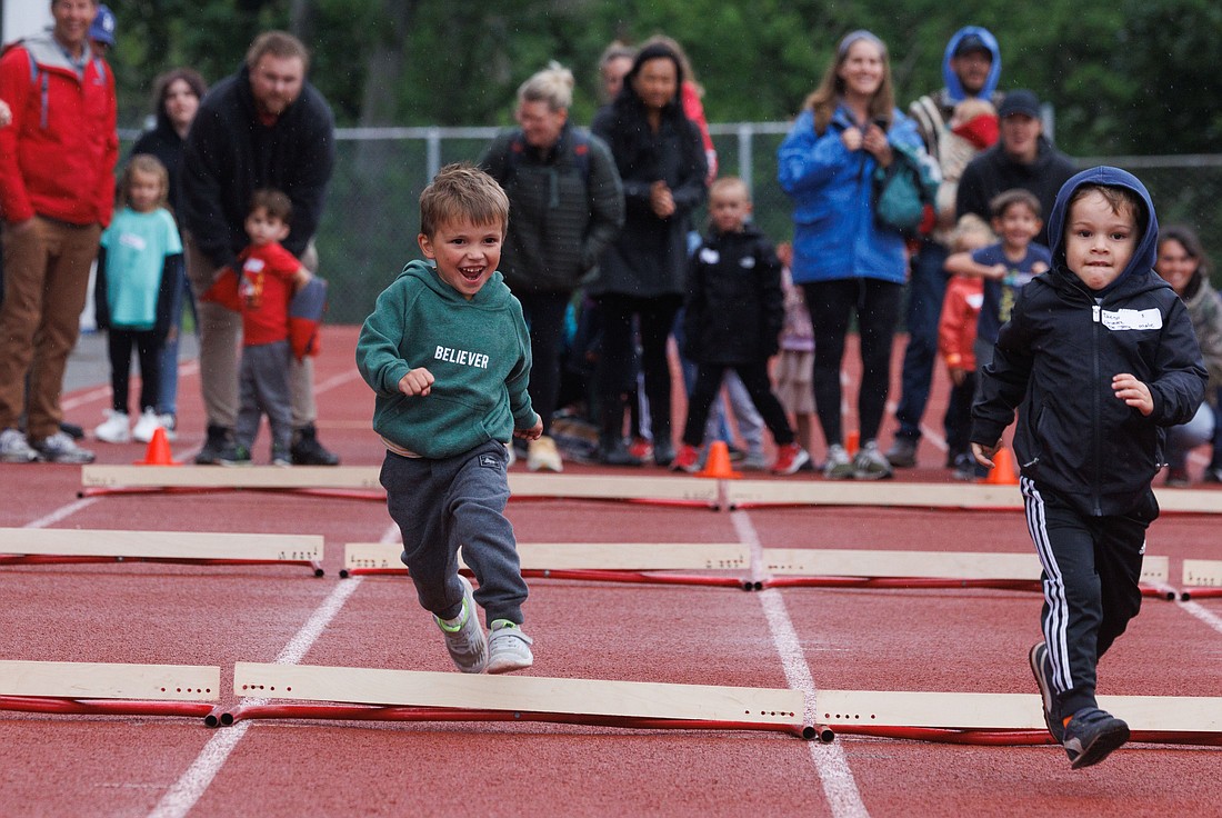 Shaw Reyna, 3, left, leaps over a hurdle June 19 at the Bellingham All-Comers track and field meet at Civic Stadium.