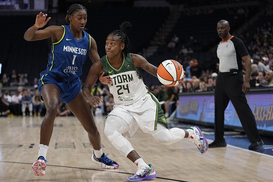 Seattle Storm guard Jewell Loyd (24) works toward the basket against Minnesota Lynx guard Diamond Miller (1) during the first half of a WNBA basketball game Tuesday, June 27, 2023, in Minneapolis.