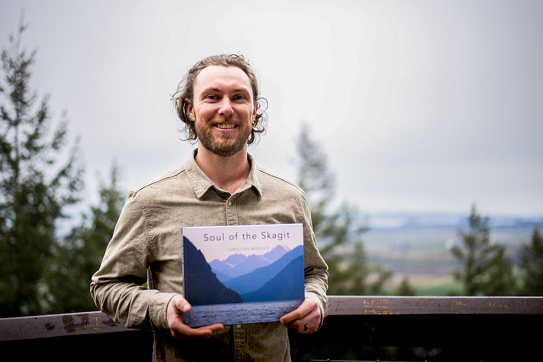 Christian Murillo holds his recently released book, "Soul of the Skagit" at Little Mountain Park in Mount Vernon. The book follows the path of the Skagit River from its source to where it flows into Puget Sound. The Bend, Oregon author spent about three years researching, interviewing, photographing and writing.