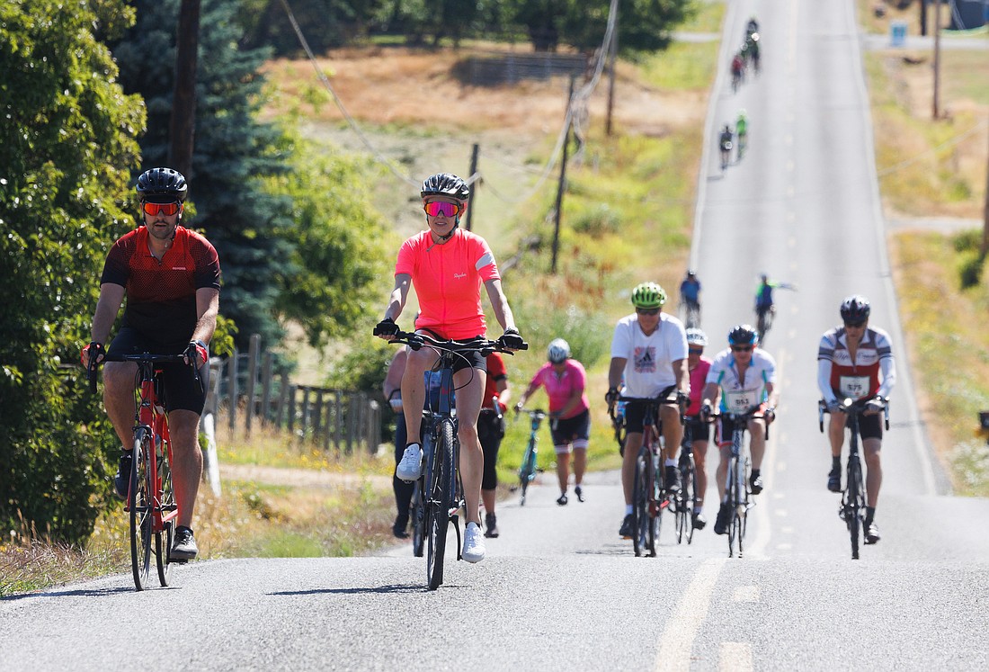 Riders pedal slowly up Douglas Road in Ferndale July 22 during the 18th annual Tour de Whatcom charity bicycle ride.