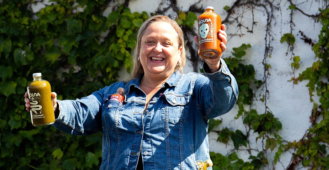 Michelle Schutte, owner of HOSA hot sauce and local artist, shows off some of her favorite sauces July 12. The name of the company is derived from the first two letters of the words hot sauce. "It's devoid of personal attachment or reference to anything else," Schutte said.
