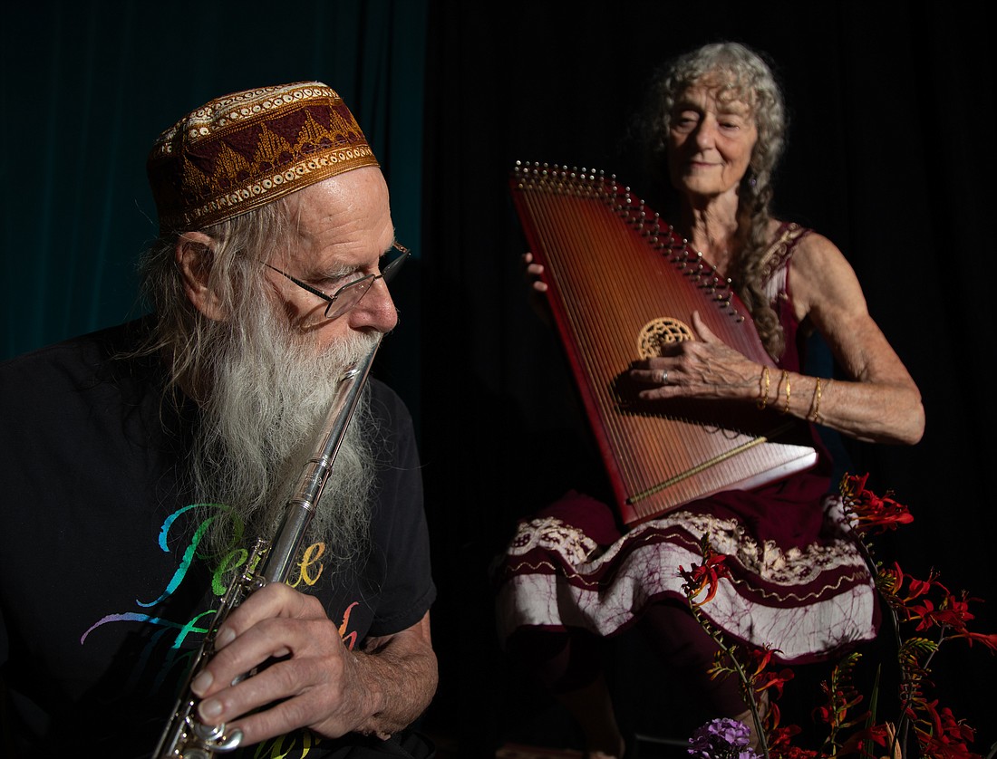 Dean, left, and Dudley Evenson play music on the flute and zither, respectively, in their Bellingham studio Wednesday, July 12. The couple are founders of the record label Soundings of the Planet.