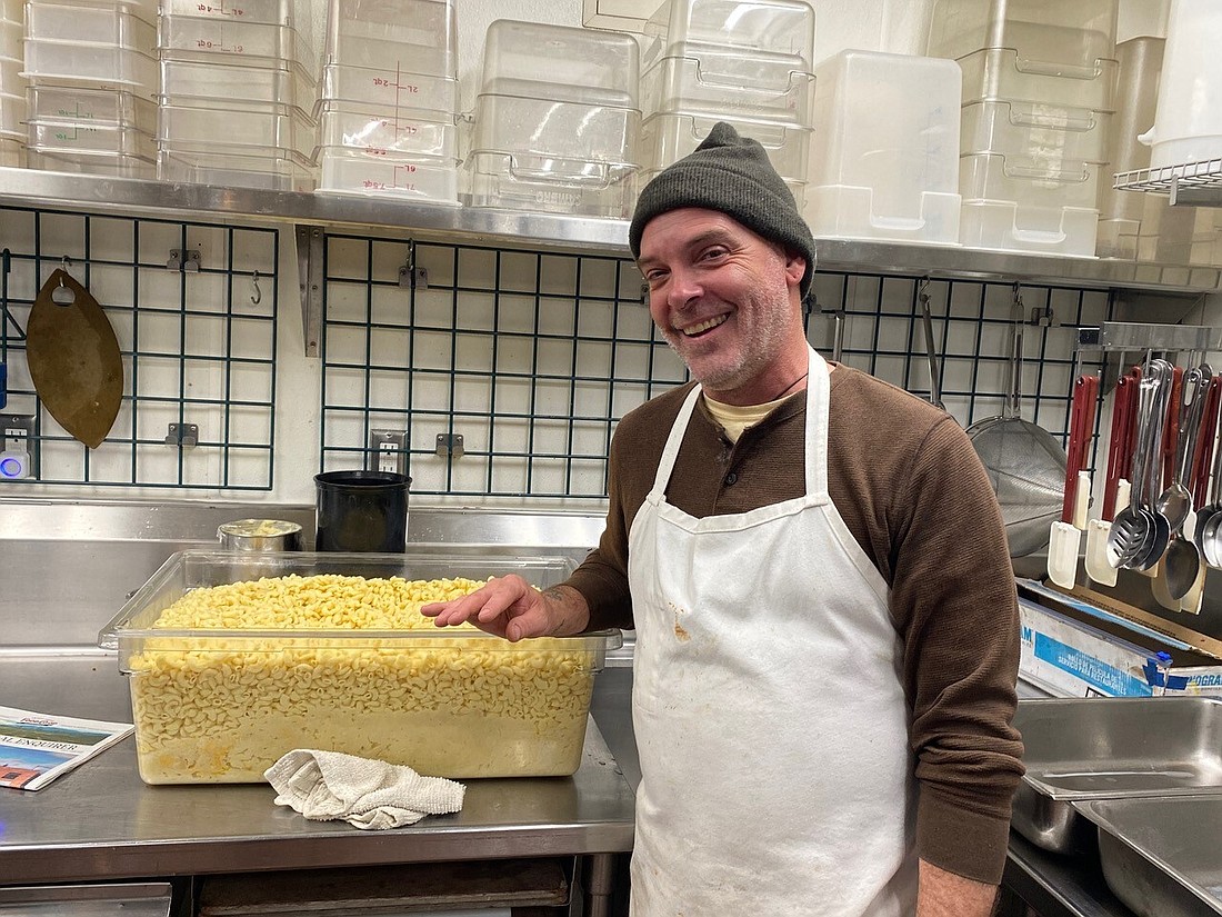 Charles Claassen poses for a photo with a giant tub of mac and cheese. Claassen was a fan of inventive cooking, a passion that helped shape the cuisine served at the Environmental Learning Center. He died July 27 in a paddleboarding accident at the age of 52.