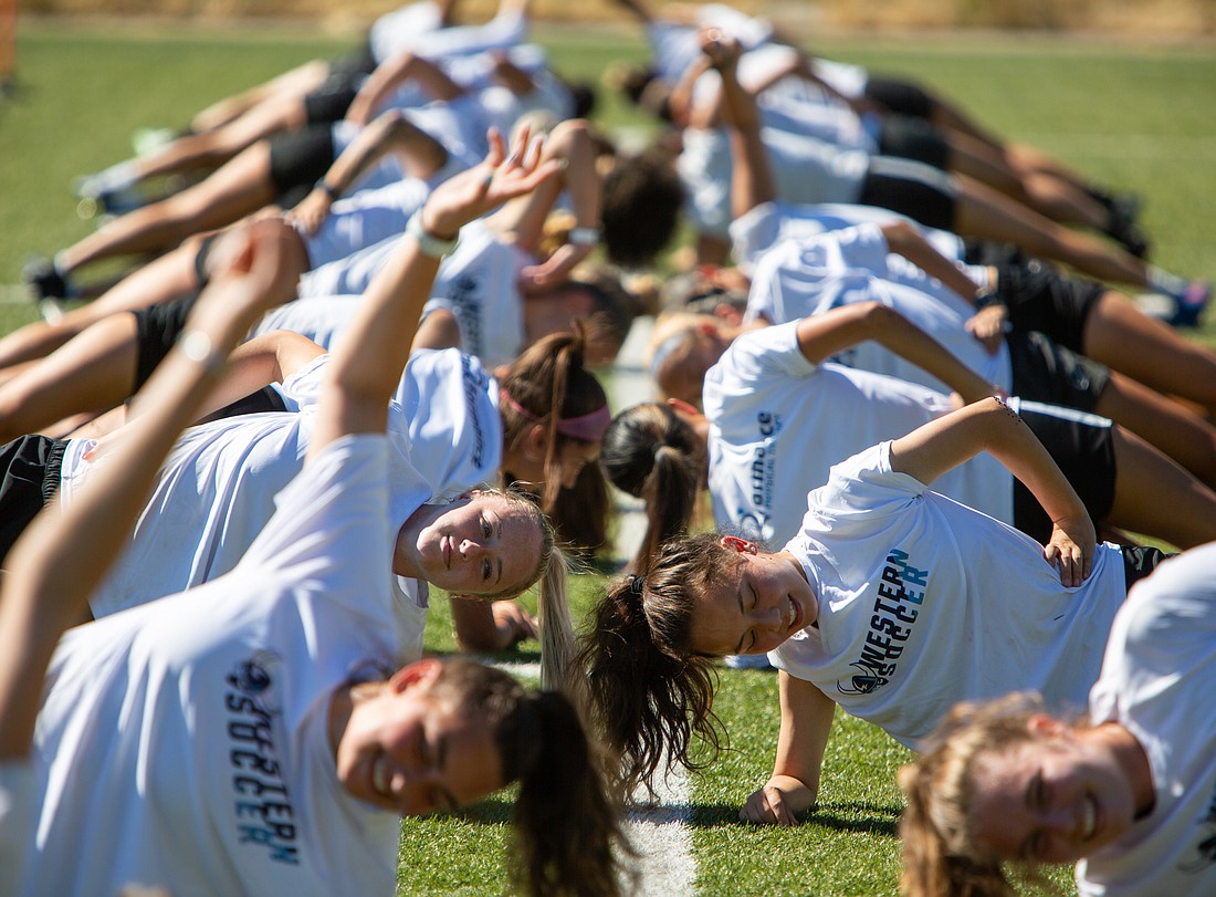 The WWU women's soccer team does side planks during practice in August 2022. The Vikings have a pair of upcoming preseason games between Aug. 19–22.