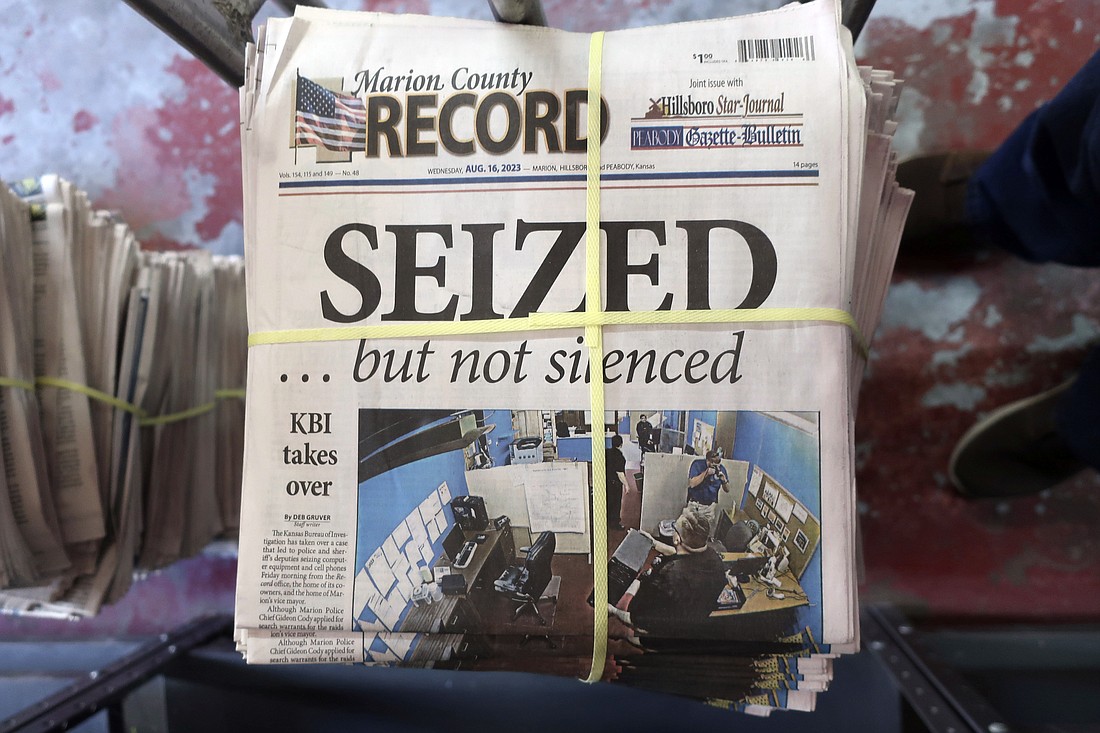 A stack of the latest weekly edition of the Marion County Record sits in the back of the newspaper's building, awaiting unbundling, sorting and distribution, Wednesday, Aug. 16, in Marion, Kansas. The newspaper's front page was dedicated to two stories about a raid by local police on its offices and the publisher's home on Aug. 11.