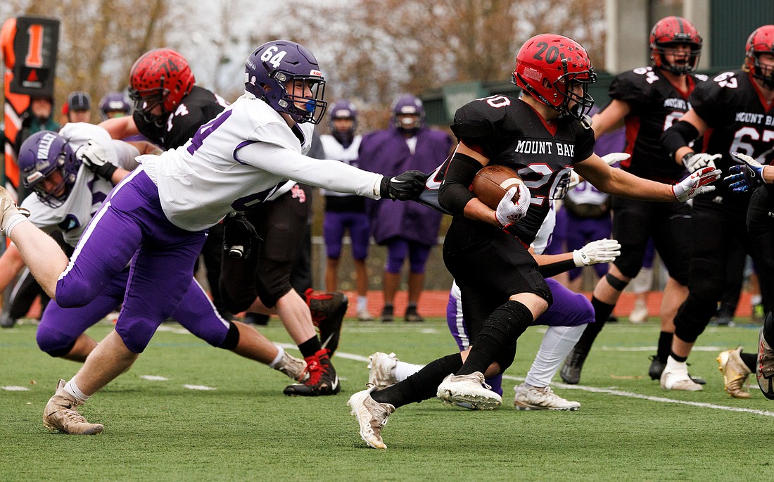 Nooksack Valley’s Brady Ackerman slows down Mount Baker’s Wilhelm Maloley by grabbing his jersey on Nov. 26, 2022, in the 1A state semifinals. Mount Baker went on to win the game 14-13.