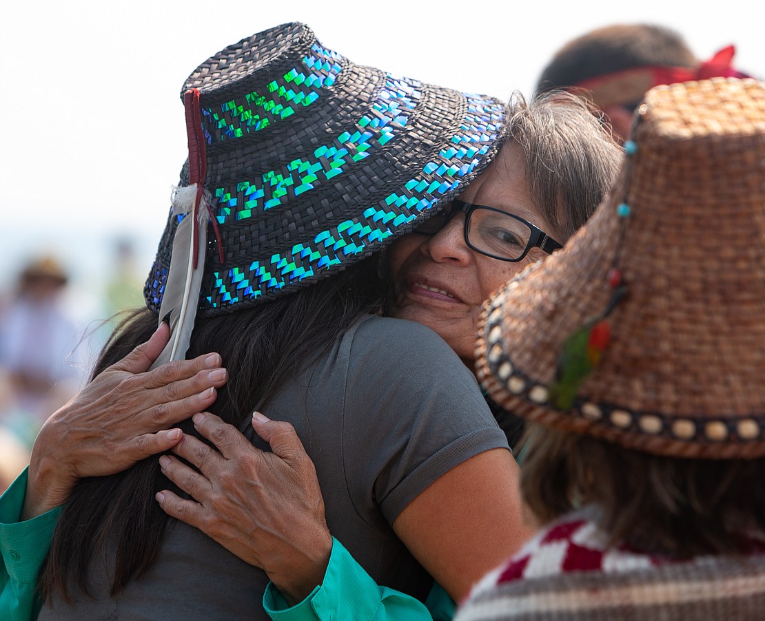 Lummi Nation member Cu-se-ma-at, Cathy Ballew, receives a hug during the ceremony.