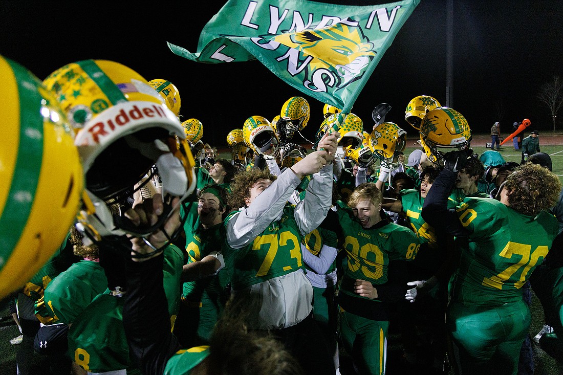 Lynden players celebrate after beating Enumclaw 41-14 Nov. 26, 2022, in the 2A state semifinals to advance to their second-straight championship game. The Lions went on to win the title, defeating North Kitsap, and will enter the 2023 season as two-time defending champions.