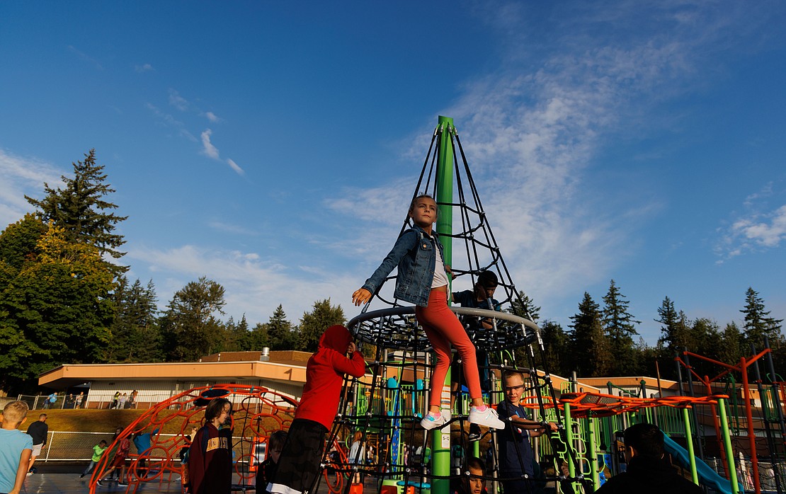 Third-grader Jenna Dawson gets a bird's eye view of the new playground near the top of a spinning rope tower Aug. 31 at Silver Beach Elementary in Bellingham.