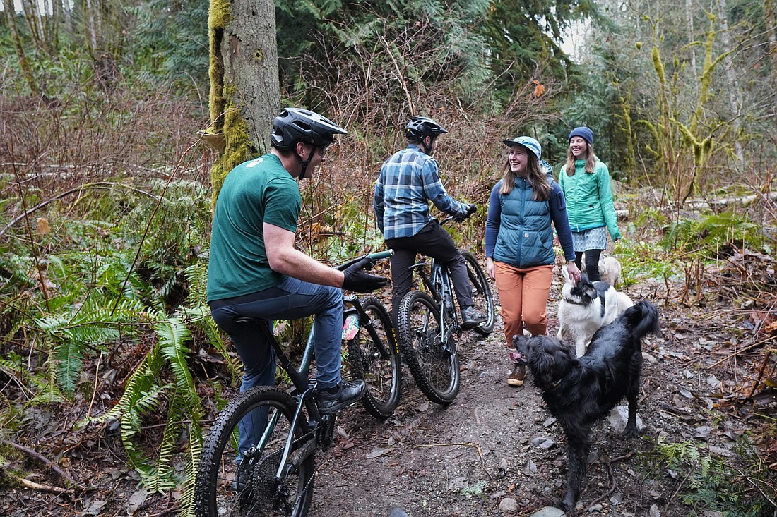 Mountain bikers Jeff Bowers and Henry Lawrence stop along a narrow path of the Y Road Trail to chat with dog walkers Sarah Finger and Michelle Cousins, both of Bellingham. The Y Road Trail makeover, which will include 17 miles of multi-use trails, is part of the Baker to Bellingham Non-Motorized Recreation Plan.