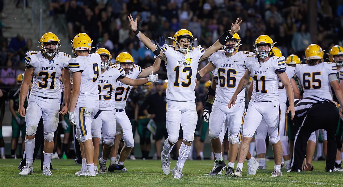 Ferndale’s Bishop Ootsey (13) celebrates with his teammates Friday, Sept. 1, after beating Lynden 17-14 on the road and breaking the Lions’ 24-game win streak.