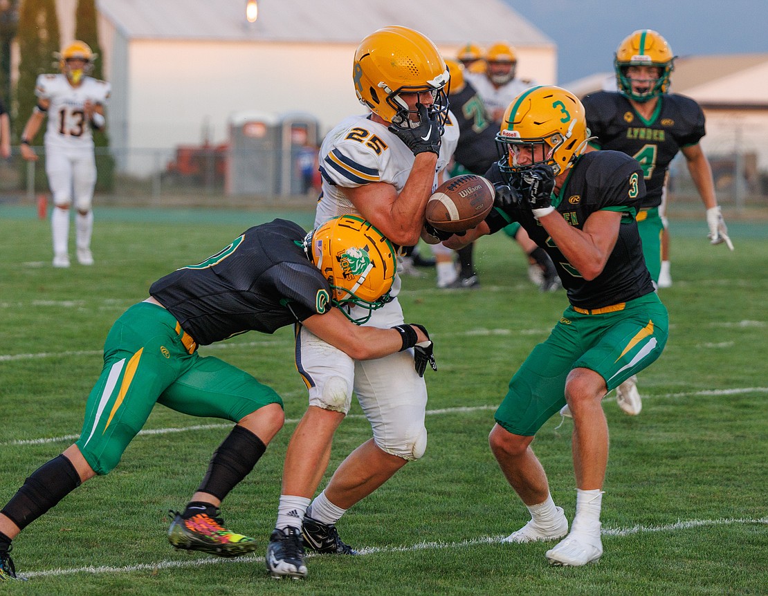 Lynden’s Weston VanDalen (3) and Cooper Moore break up a pass intended for Ferndale's Conner Walcker.