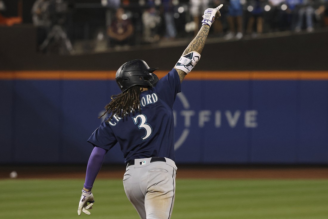 Seattle Mariners' JP Crawford celebrates as he rounds the bases after hitting a home run during the ninth inning of a baseball game against the New York Mets, Saturday, Sept. 2, 2023, in New York.
