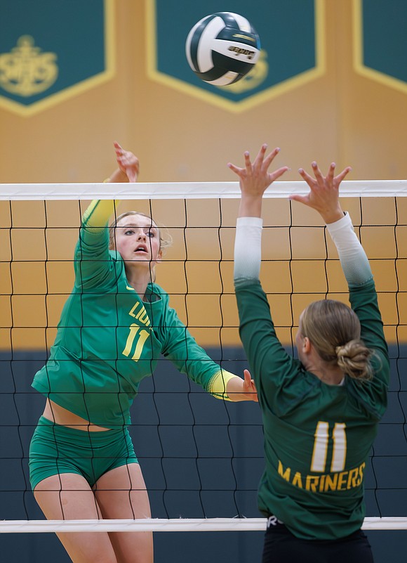 Lynden's Rian Stephan spikes the ball past the Sehome defense.