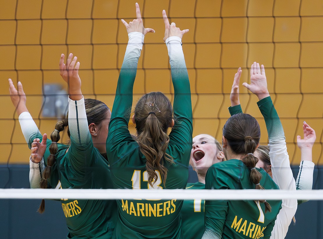 Sehome players celebrate a lead in the first set against Lynden.