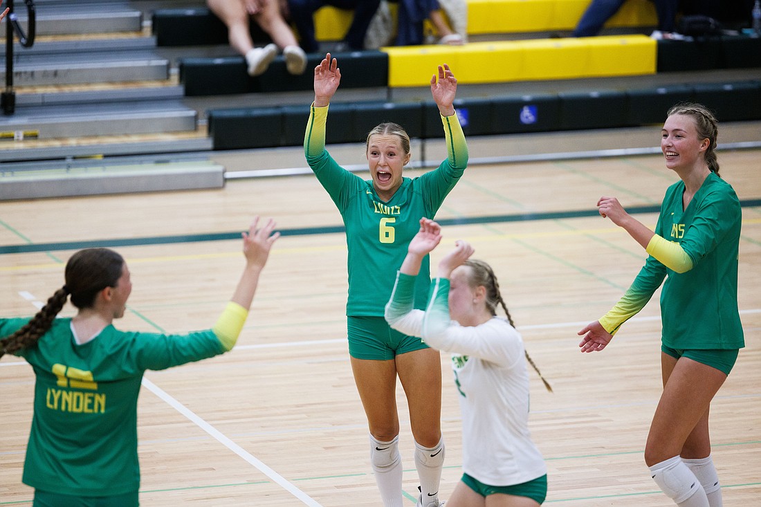 Lynden players celebrate winning the second set against Sehome Wednesday, Sept. 6, as the Lions beat the Mariners in straight sets (25-23, 25-9, 25-14) in Bellingham.