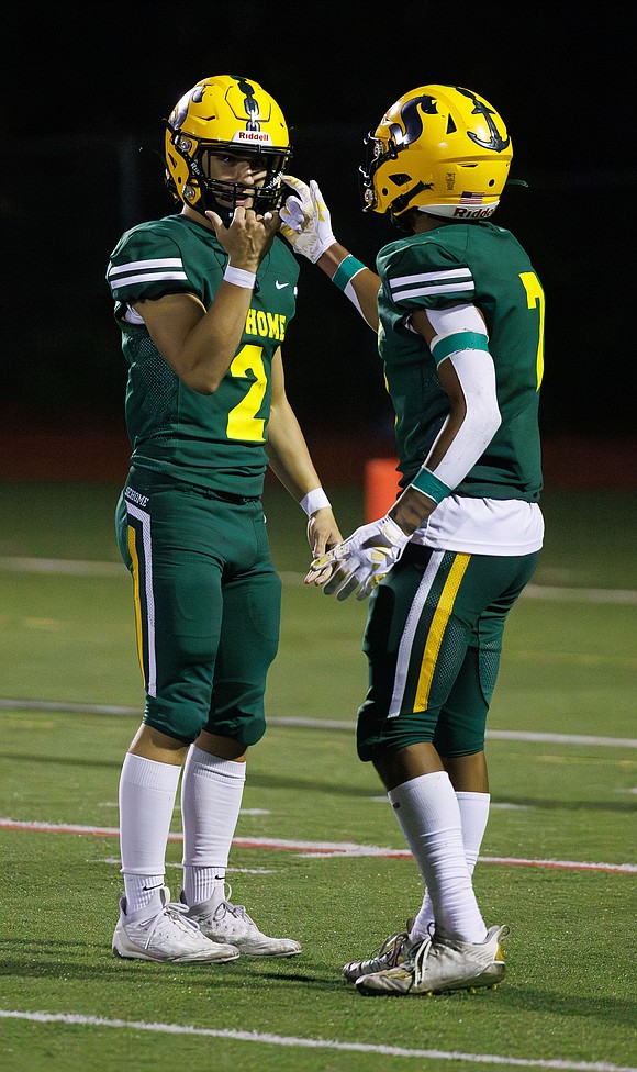 Sehome's Nolan Wright and Andre Watson end a celebratory handshake after Watson’s touchdown.