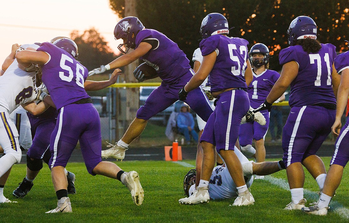 Nooksack Valley’s Colton Lentz leaps over a Connell player for a touchdown.