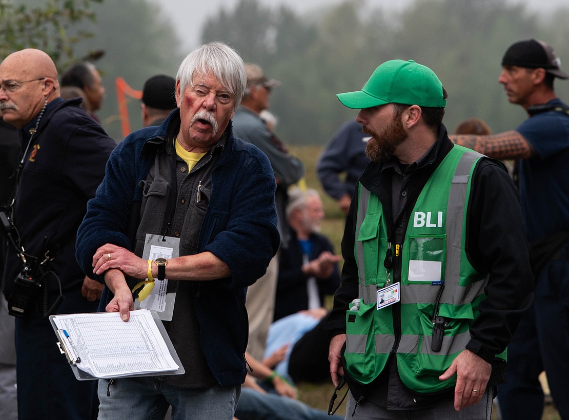 Dave Bestle, left, and Airport Operations Manager Alex Young chat during the exercise.