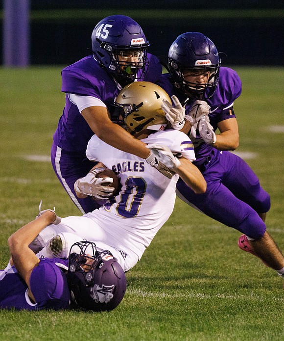 A trio of Nooksack Valley defenders stop Connell’s Jackson Price.
