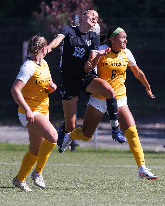 Western Washington University’s Claire Potter heads the ball between two Cal State Los Angeles players.