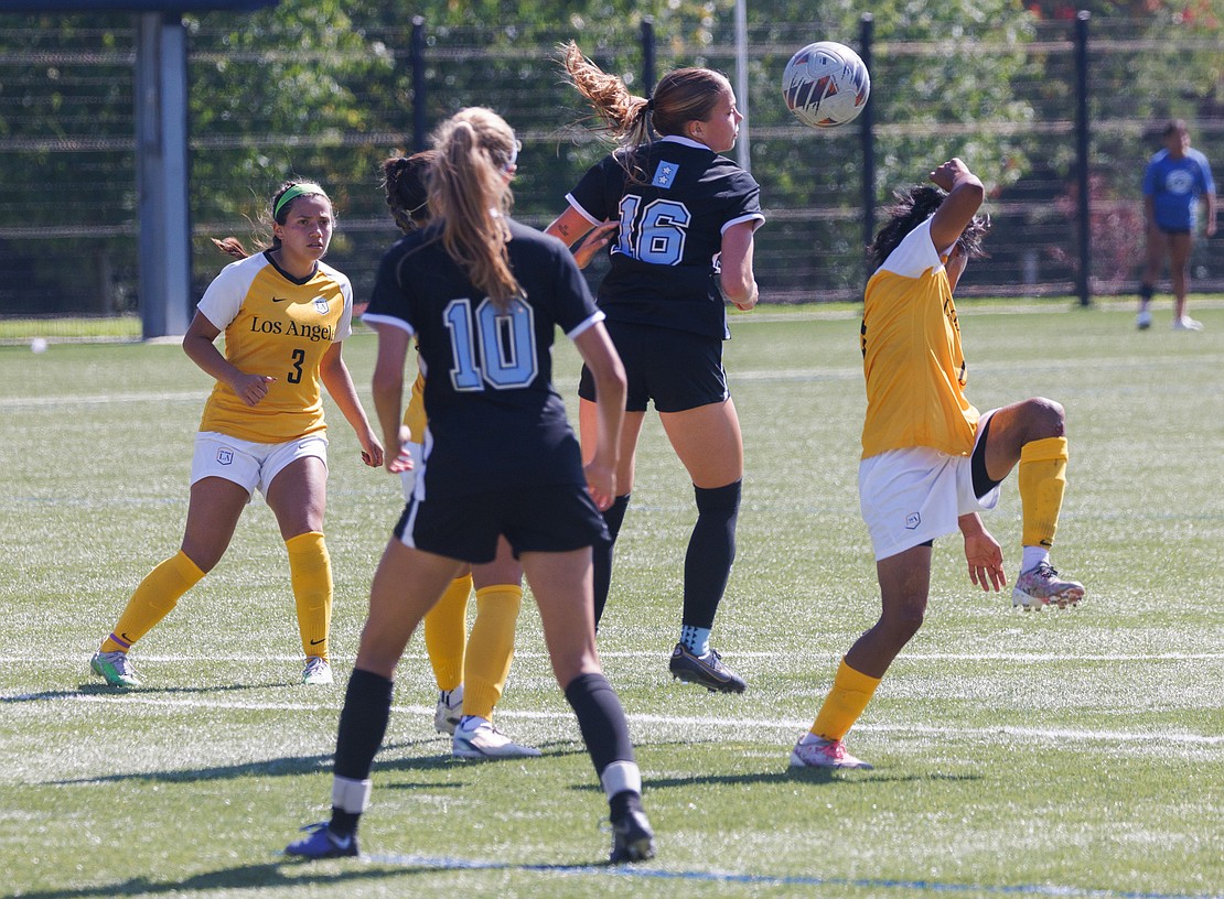 Western Washington University’s Gracen Crosby (16) tries to head the ball toward teammate Claire Potter.