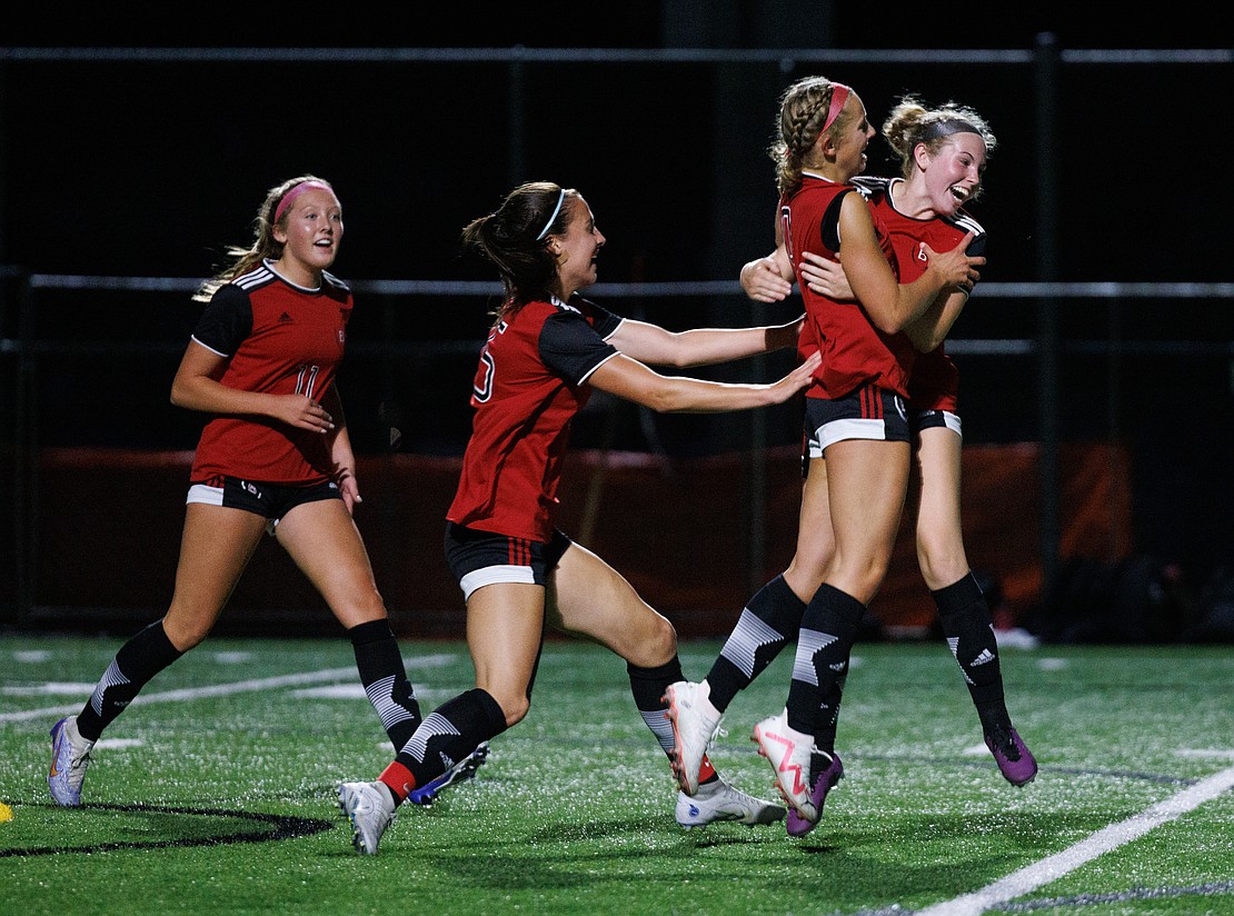 Bellingham’s Ivy Newell, right, celebrates her goal with teammates Tuesday, Sept. 12 as the Bayhawks tied Sehome 2-2 in Bellingham.