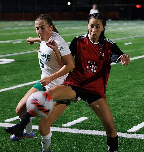 Sehome’s Katherine Quinn and Bellingham’s Sophie Brady battle for the ball in the second half.
