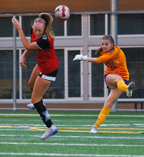 Sehome’s Clarice Hickey kicks the ball out as Bellingham’s Ella Morrow turns away from the incoming ball.