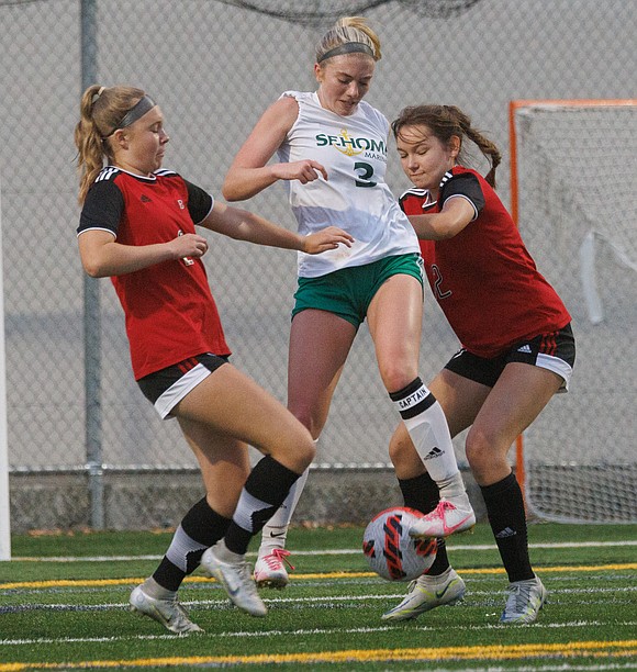 Sehome’s Evelyn Sherwood kicks the ball away from Bellingham defenders.