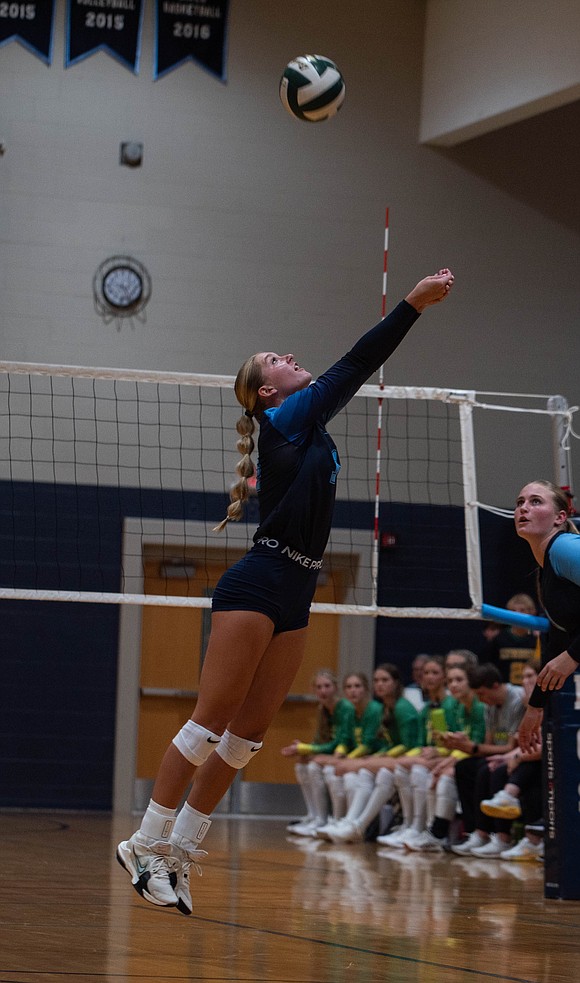 LC middle blocker Allison Wright bumps the ball over her shoulder.