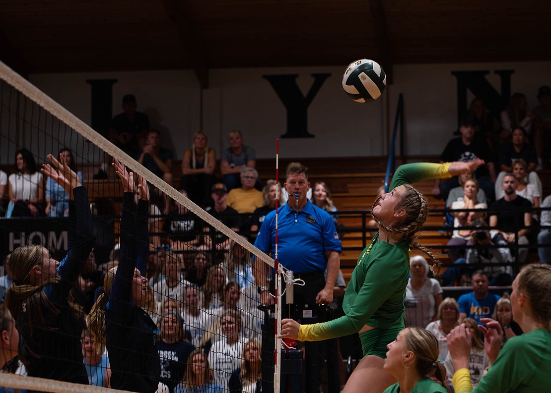 Lynden middle blocker Finley Parcher rises to hit the ball.