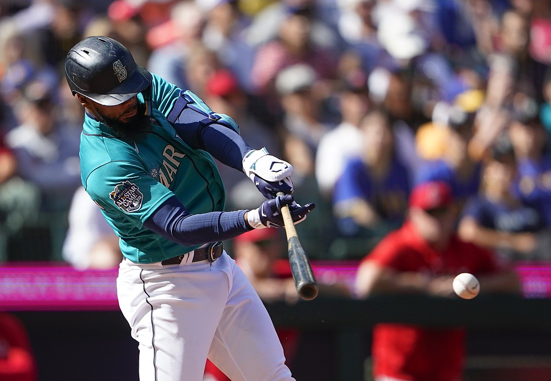 Seattle Mariners' Teoscar Hernandez hits a single to score Julio Rodriguez against the Los Angeles Angels during the fifth inning of a baseball game Wednesday, Sept. 13, 2023, in Seattle.
