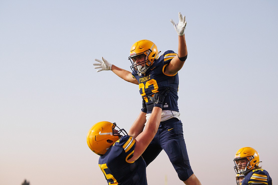 Ferndale’s Phoenyx Finkbonner is lifted into the air after scoring a touchdown Friday, Sept. 15 in Ferndale’s 22-16 win over Glacier Peak during the Golden Eagles' first game in their new stadium.