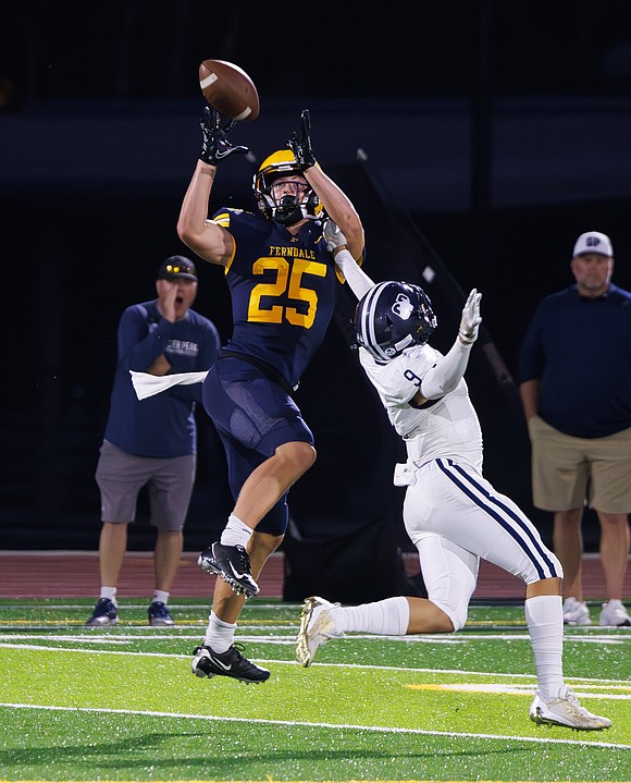 Ferndale’s Conner Walcker hauls in a pass deep into Glacier Peak territory on Friday night.
