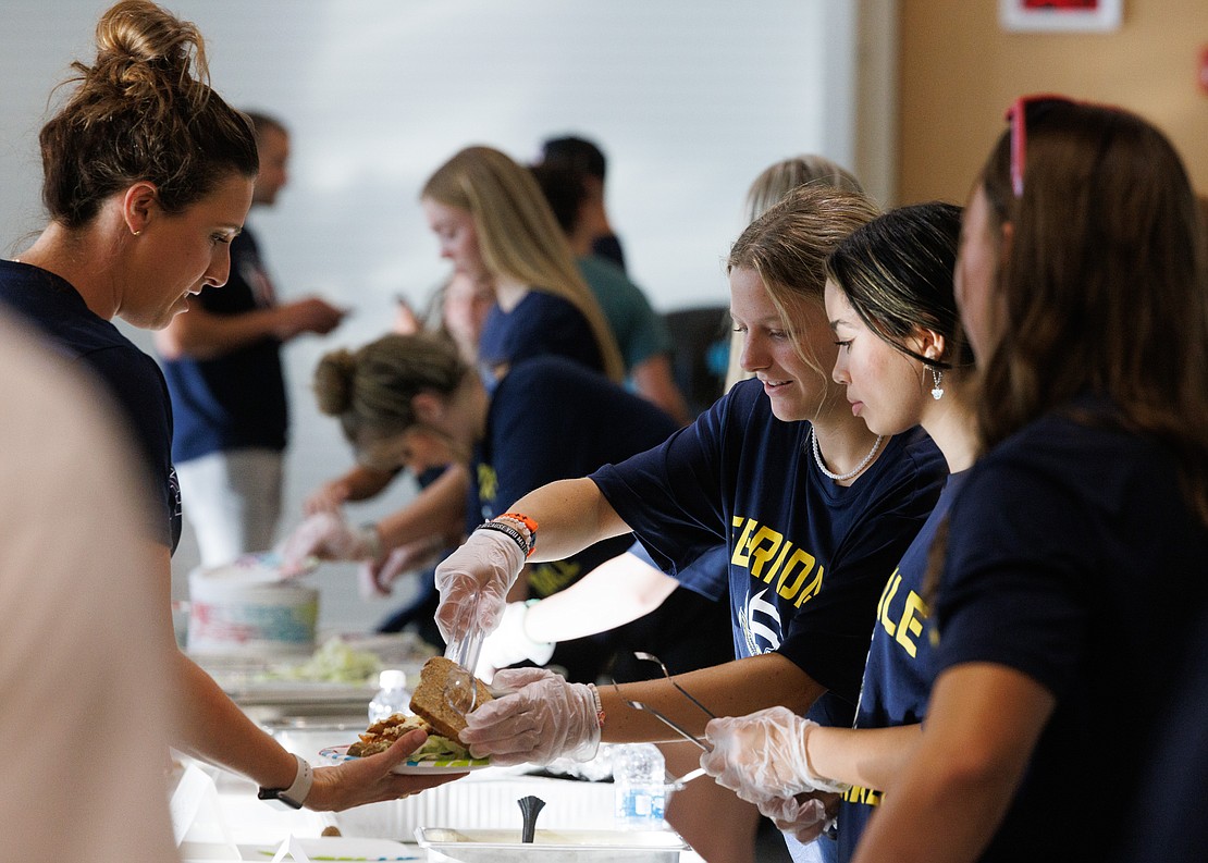 Ferndale volleyball players serve up food during the Ferndale Golden Eagles Booster Club spaghetti dinner fundraiser on Friday, Sept. 15. The club’s dinner was the first in 20-plus years, according to club president Joe Lupo.