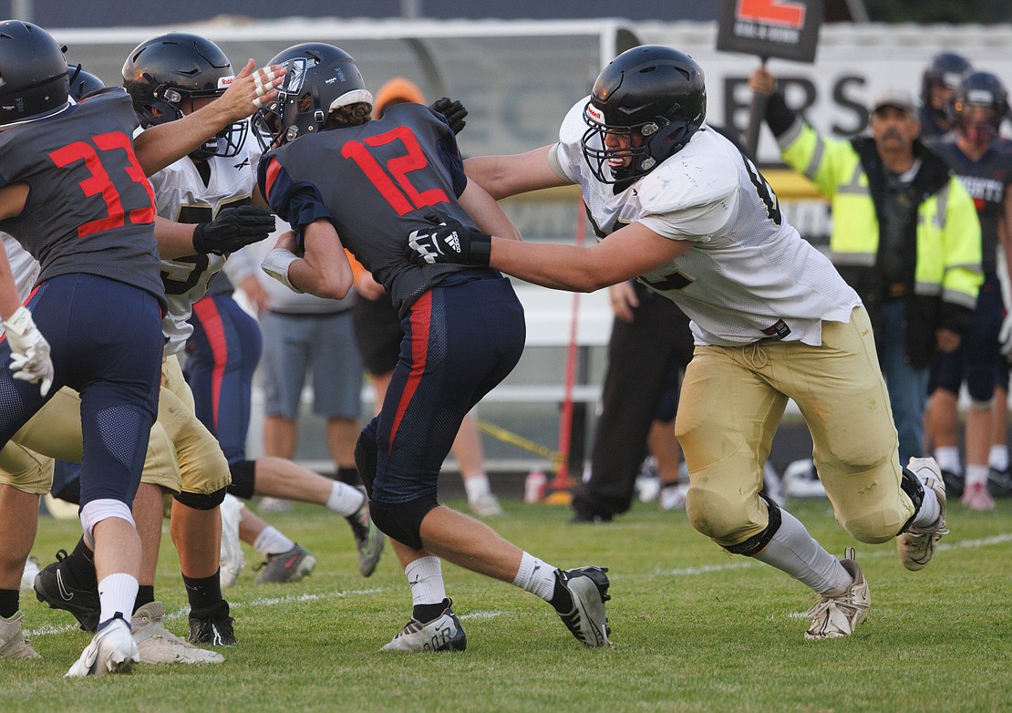 Meridian’s Lincoln Hoefer, right, sacks the quarterback for a second time.