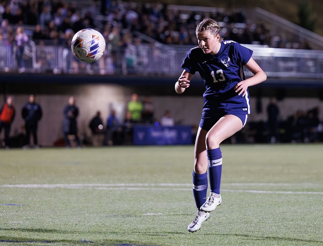 Western Washington University's Jane Hmura heads the ball toward the goal.