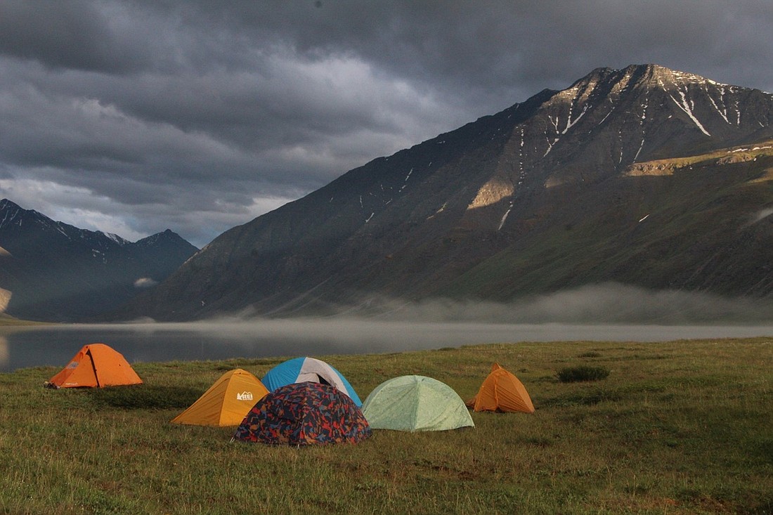 A group of tents sit near a lakeshore in the Arctic National Wildlife Refuge, where oil and gas leases recently were canceled by the Biden administration. Activists believe the entire 19.6-million-acre refuge should be protected in perpetuity.