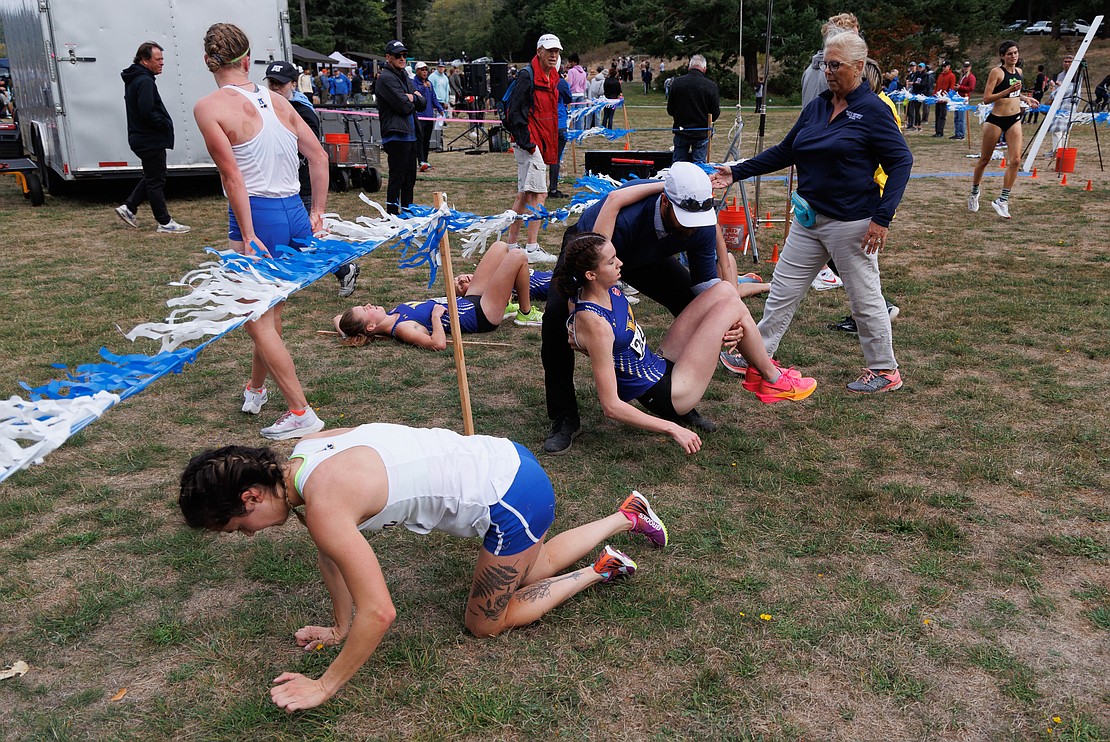 Runners crawl and are assisted at the finish line.